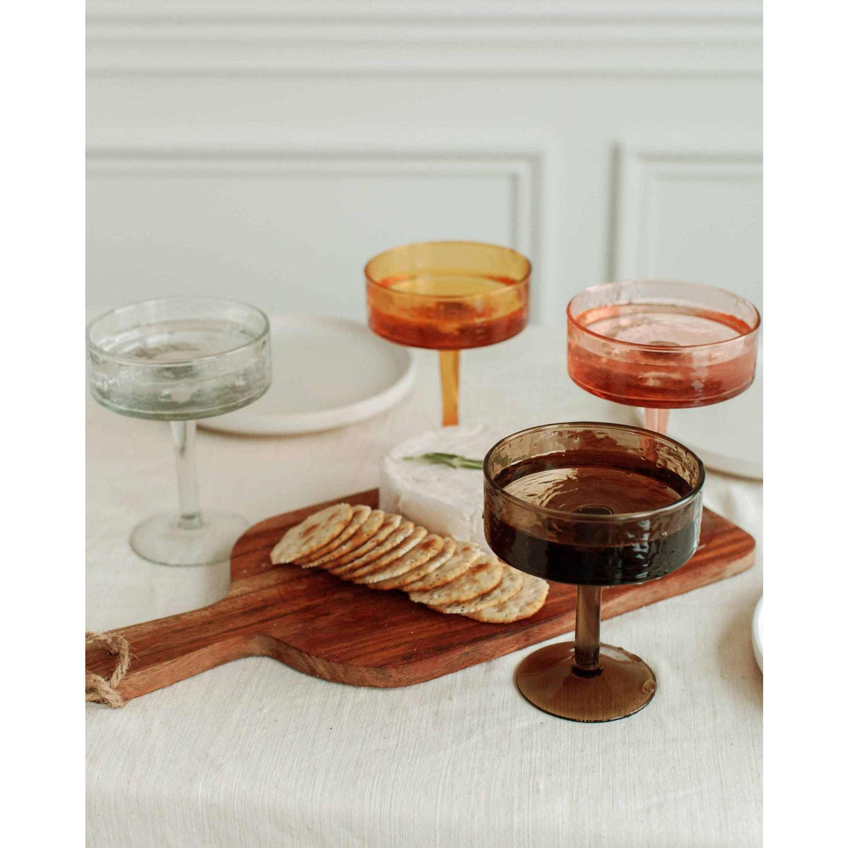 Blush Handblown Hammered Coupe Mixed Beverage Glasses are sold individually.