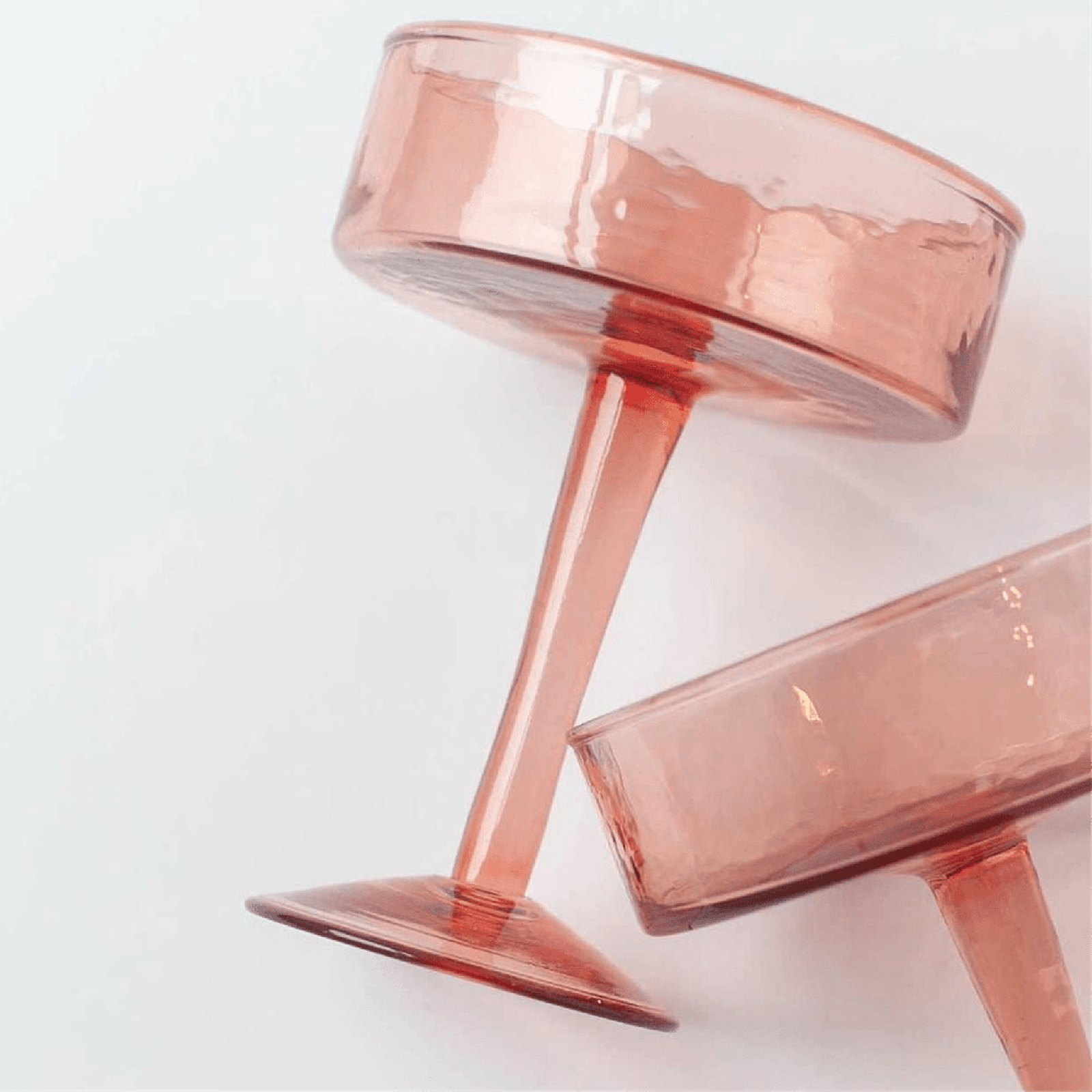 Blush Handblown Hammered Coupe Mixed Beverage Glasses are sold individually.