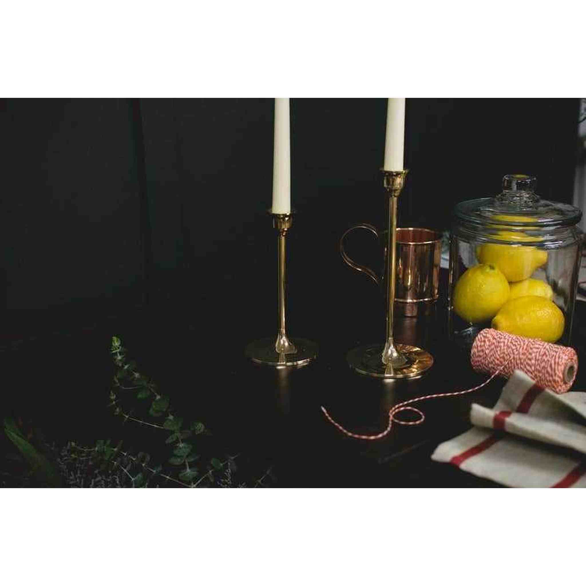 A set of three brass candlesticks.