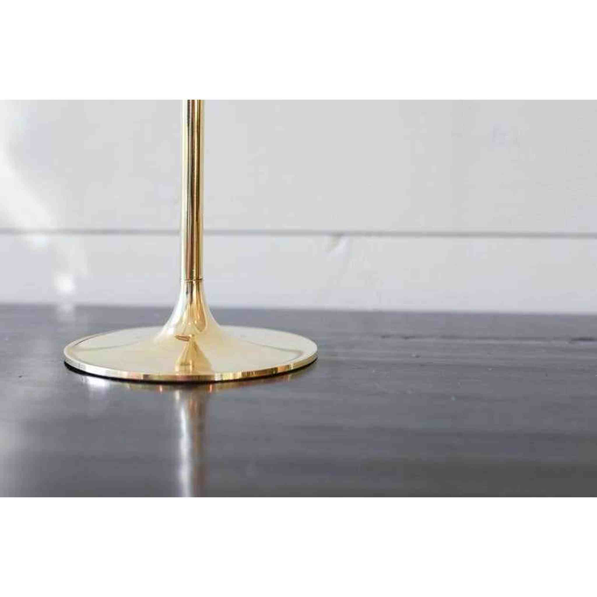 A set of three brass candlesticks.