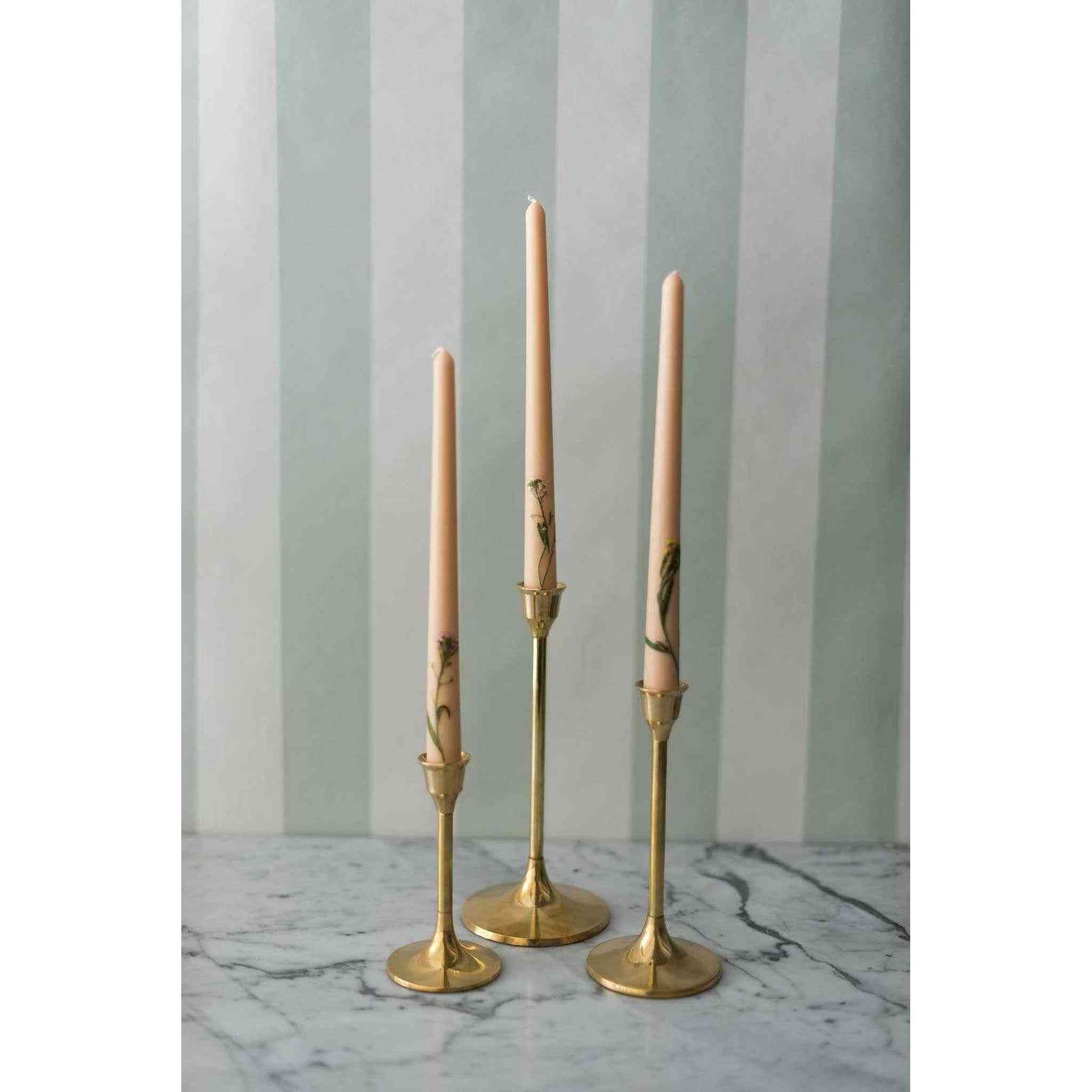 A set of three brass candlesticks.
