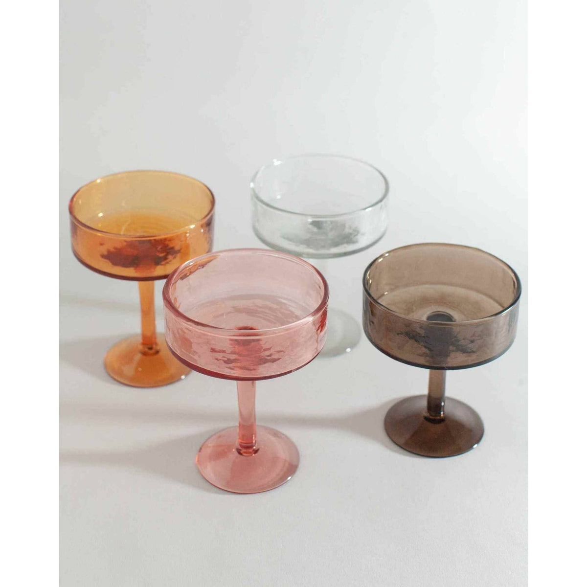 Blush Handblown Hammered Coupe Mixed Beverage Glasses are sold individually.